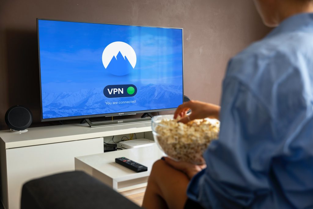 Person watching TV with VPN connected status showing internet security and privacy protection at home